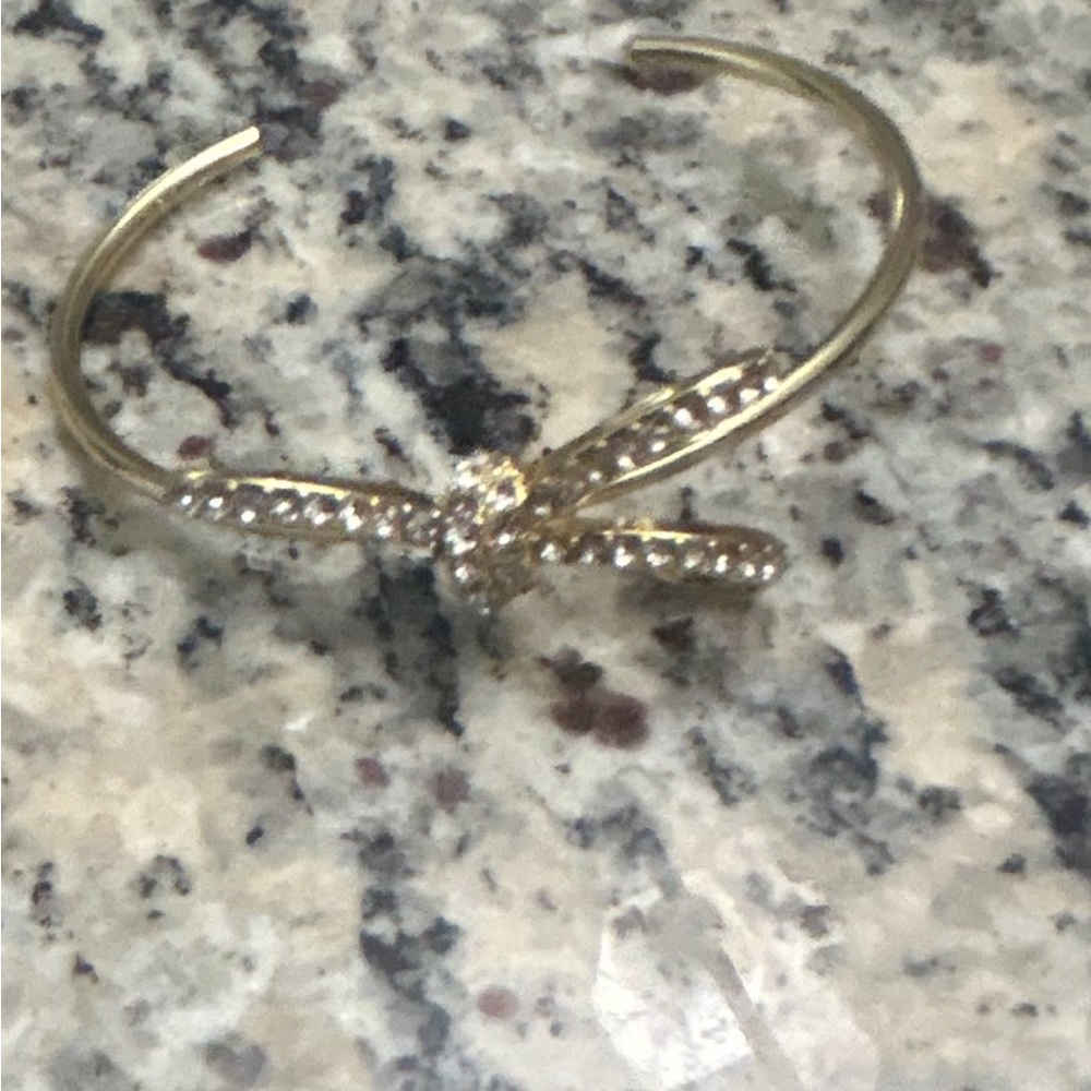 Gold rhinestone bow bracelet.